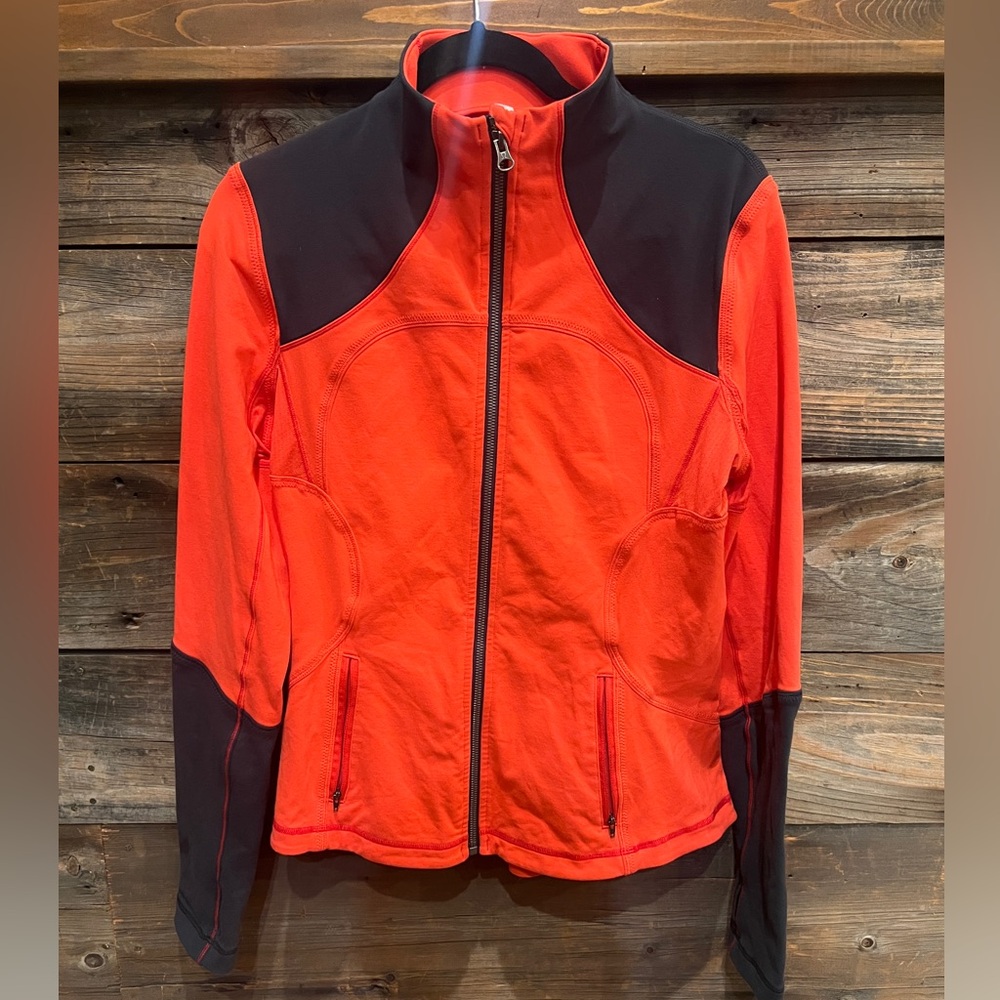 Rare Lululemon jacket, size 12, in a dark grey and orange color!